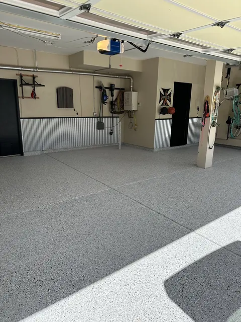 Large residential garage with a finished gray decorative flake floor