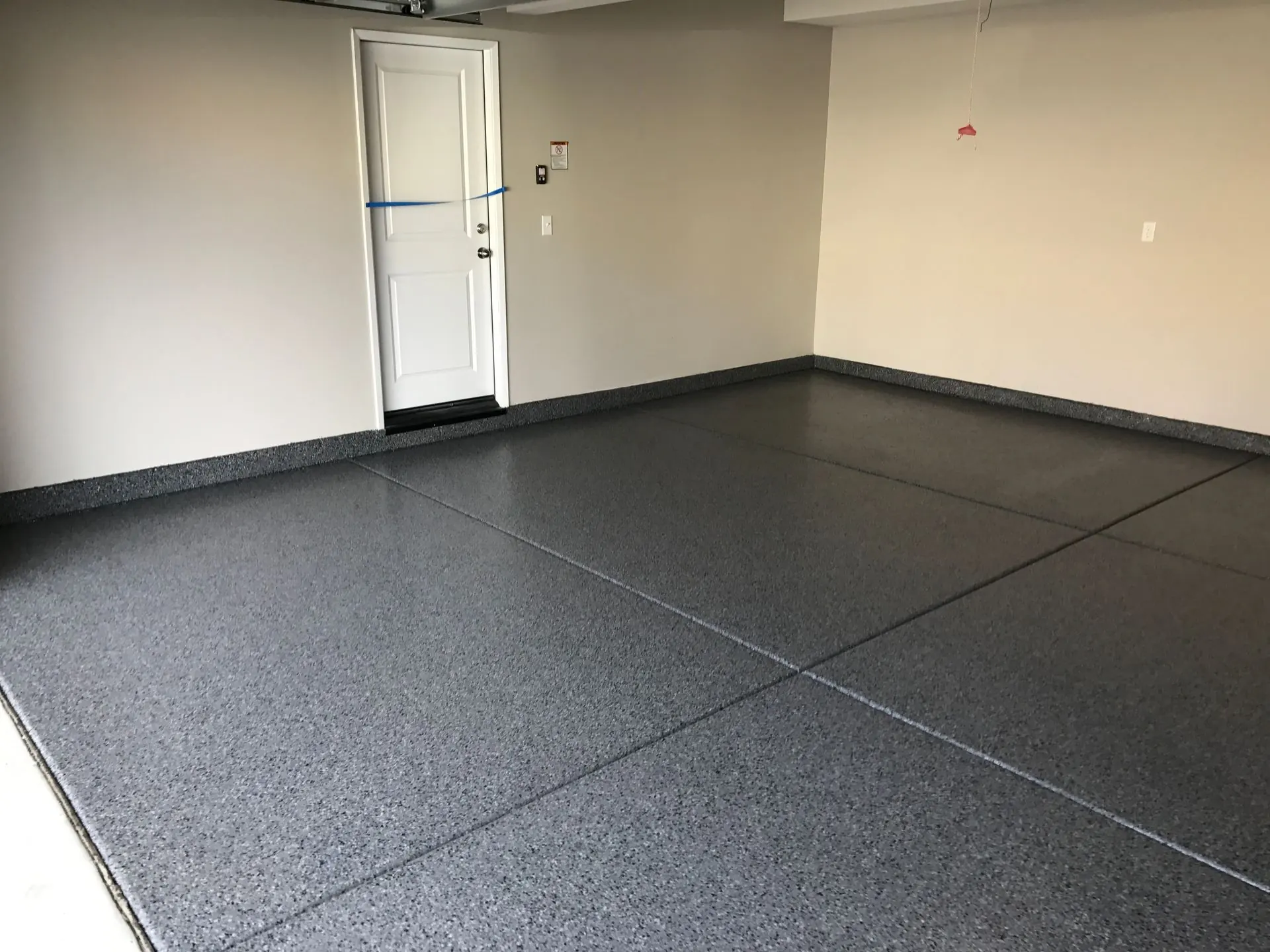 Gray decorative flake garage floor with a protective clear topcoat