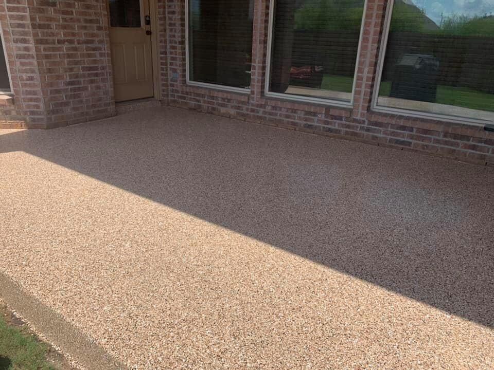 Tan decorative flake concrete coating on a patio